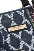 Close-up of the Nicole Lee USA logo on the Bosque de Amor denim tote bag featuring unique patterns.